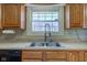 Kitchen details include a stainless-steel sink, faucet and countertops, all illuminated by natural light from the window at 6170 Shelbyville Rd, Indianapolis, IN 46237