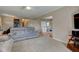 Open-concept living area with a spacious sofa, flowing into the dining area and hallway at 6170 Shelbyville Rd, Indianapolis, IN 46237