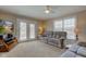 Living room with neutral color scheme and ample seating, next to the sliding door entrance at 6170 Shelbyville Rd, Indianapolis, IN 46237