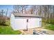 Spacious outbuilding with gray roof, basketball hoop, concrete patio, and a table with chairs, perfect for various activities at 6170 Shelbyville Rd, Indianapolis, IN 46237