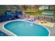 Inviting in-ground pool with a spacious deck, lounge seating, and stylish decor, creating a perfect outdoor oasis at 6170 Shelbyville Rd, Indianapolis, IN 46237