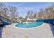 Backyard pool and deck featuring lounge seating, blue fencing and a glimpse of surrounding trees offers a relaxing atmosphere at 6170 Shelbyville Rd, Indianapolis, IN 46237