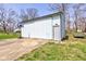 View of the white metal shed and concrete pad with basketball hoop at 6170 Shelbyville Rd, Indianapolis, IN 46237