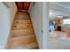 Wooden stairs lead to an unfinished space in this home at 6170 Shelbyville Rd, Indianapolis, IN 46237