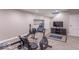 Basement area features exercise equipment, a TV and wood look floors at 6272 Turnbridge Dr, Avon, IN 46123