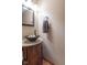 Powder room featuring a vessel sink on a wood vanity with granite top, towel ring, and decorative mirror at 6272 Turnbridge Dr, Avon, IN 46123