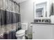 Bathroom featuring gray patterned shower curtain, black granite countertop and white vanity at 6272 Turnbridge Dr, Avon, IN 46123