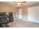Bedroom with ceiling fan, beige carpet, and white closet doors at 6272 Turnbridge Dr, Avon, IN 46123