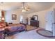 Large primary bedroom features a ceiling fan, art and comfortable dark wood furnishings at 6272 Turnbridge Dr, Avon, IN 46123