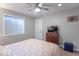 Well-lit bedroom with a ceiling fan, window, and TV on top of cabinet at 6272 Turnbridge Dr, Avon, IN 46123