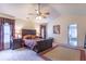 Spacious bedroom features a ceiling fan, large window and comfortable dark wood furnishings at 6272 Turnbridge Dr, Avon, IN 46123