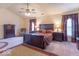 Spacious bedroom features a ceiling fan, carpet and dark wood furnishings at 6272 Turnbridge Dr, Avon, IN 46123