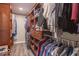 Walk-in closet with wood shelving and clothing racks with neutral walls and vinyl floors at 6272 Turnbridge Dr, Avon, IN 46123