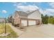 Spacious two-car garage with brick and siding exterior, complemented by a paved driveway and manicured landscaping at 6272 Turnbridge Dr, Avon, IN 46123