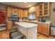Well-lit kitchen with stainless steel appliances, center island, and ample cabinet space at 6272 Turnbridge Dr, Avon, IN 46123