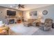 Bright living room features a stone fireplace, ceiling fan, and comfortable seating, perfect for relaxation at 6272 Turnbridge Dr, Avon, IN 46123
