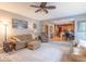 Cozy living room with plush seating, a ceiling fan, and an open floor plan that flows into the kitchen area at 6272 Turnbridge Dr, Avon, IN 46123