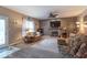 Spacious living room featuring a stone fireplace, large windows, neutral walls, and comfortable seating area at 6272 Turnbridge Dr, Avon, IN 46123