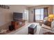 Comfortable living room featuring a plush sofa, ottoman, and entertainment center at 6272 Turnbridge Dr, Avon, IN 46123