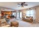Inviting living room with plush seating, a ceiling fan, and an open floor plan that connects to the kitchen at 6272 Turnbridge Dr, Avon, IN 46123