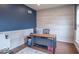 Bright office space features wood floors, stylish accent wall, and a functional desk setup at 6272 Turnbridge Dr, Avon, IN 46123
