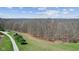 Panoramic aerial view of a rural property with a windmill, pond, solar panels, and tree-lined drive at 6351 Dixon Rd, Columbus, IN 47201
