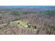 Aerial perspective of a secluded property nestled within a dense forest, featuring a tranquil pond at 6351 Dixon Rd, Columbus, IN 47201