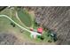 Aerial view of a log cabin with a pond, outbuildings, and trees at 6351 Dixon Rd, Columbus, IN 47201