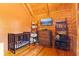 Cozy bedroom with wood paneling, beamed ceilings, and a large screen tv at 6351 Dixon Rd, Columbus, IN 47201