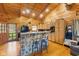 Kitchen featuring wooden cabinets, stone breakfast bar, and stainless steel appliances at 6351 Dixon Rd, Columbus, IN 47201