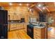 Wood-paneled kitchen featuring stone countertops and modern stainless steel appliances at 6351 Dixon Rd, Columbus, IN 47201