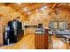 Cozy kitchen features wood cabinets, beamed ceilings, and stainless steel appliances at 6351 Dixon Rd, Columbus, IN 47201