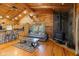 Open-concept living room with stone fireplace, wood floors, and vaulted ceilings at 6351 Dixon Rd, Columbus, IN 47201