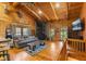 Cozy living room with wood walls, stone fireplace, and wood-beamed ceiling at 6351 Dixon Rd, Columbus, IN 47201