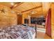 Spacious bedroom featuring wood walls, a plaid bedspread, and office nook at 6351 Dixon Rd, Columbus, IN 47201