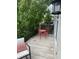 Charming balcony with red bistro set, greenery and black railing at 6379 Fairfield St, Whitestown, IN 46075