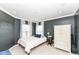 Bedroom with gray walls, white trim, natural light, a bed, and a white wardrobe cabinet at 6379 Fairfield St, Whitestown, IN 46075