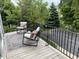 Comfortable seating area on deck overlooking green scenery through black metal railing at 6379 Fairfield St, Whitestown, IN 46075
