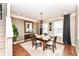 Cozy dining room featuring stylish light fixtures, dark curtains and hardwood floors at 6379 Fairfield St, Whitestown, IN 46075