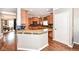 Well-equipped kitchen with a breakfast bar, granite countertops, and modern appliances at 6379 Fairfield St, Whitestown, IN 46075