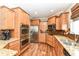 Gourmet kitchen featuring stainless steel appliances, granite countertops, and custom cabinetry at 6379 Fairfield St, Whitestown, IN 46075