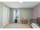 Inviting bedroom with a soft color palette, natural light, and playful patterned accent wall at 6476 W Mulberry Way, Greenfield, IN 46140