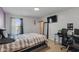 Bright bedroom with a modern workspace, large window and comfortable queen size bed at 6476 W Mulberry Way, Greenfield, IN 46140