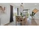 Bright dining room features modern lighting, a sliding glass door, and an elephant art theme at 6476 W Mulberry Way, Greenfield, IN 46140