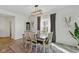 Well-lit dining room boasts contemporary light fixture, neutral paint, and seating for six at 6476 W Mulberry Way, Greenfield, IN 46140