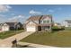Aerial view of a two-story home featuring a basketball hoop, brick accents, and a well-maintained front yard at 6476 W Mulberry Way, Greenfield, IN 46140
