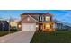 Charming two-story home featuring a basketball hoop, brick accents, and a well-maintained front yard at 6476 W Mulberry Way, Greenfield, IN 46140