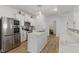 Bright kitchen featuring stainless steel appliances, white cabinetry, and a spacious center island at 6476 W Mulberry Way, Greenfield, IN 46140