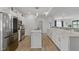 Modern kitchen featuring stainless steel appliances, white cabinetry, and a spacious center island at 6476 W Mulberry Way, Greenfield, IN 46140