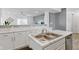 Modern kitchen sink with stainless steel faucet, white cabinetry, and marble backsplash at 6476 W Mulberry Way, Greenfield, IN 46140